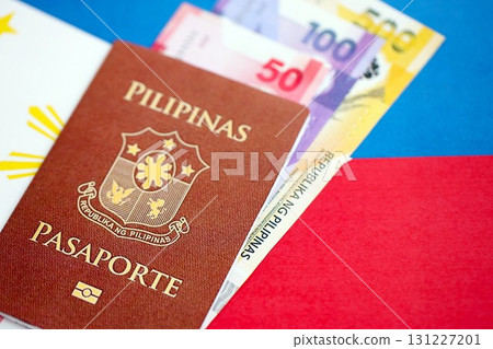 Philippines peso currency money bills and passport lies on flag. The concept of travel and vacation 131227201