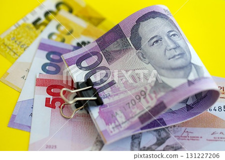 Philippines peso money bills in big amount on yellow. Finance and banking concept Philippines peso money bills in big amount on yellow. Finance and banking concept 131227206