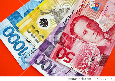 Philippines peso money bills in big amount on red. Finance and banking concept 131227207