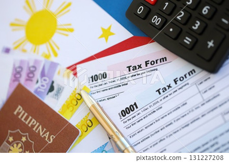 Philippines peso money bills and calculator with tax form on flag. Taxation and accounting concept 131227208