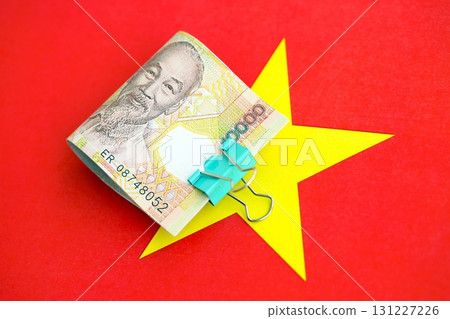 Vietnamese dong currency money bills lies on flag. The concept of business and investment 131227226