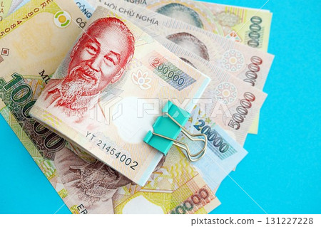 Vietnamese dong money bills in big amount on blue. Finance and banking concept 131227228