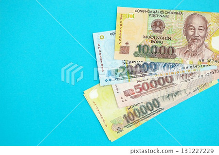 Vietnamese dong money bills in big amount on blue. Finance and banking concept 131227229
