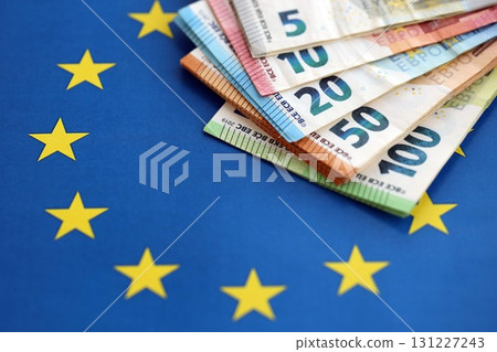 European eur currency money bills on Euro union blue flag close up 131227243