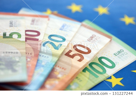 European eur currency money bills on Euro union blue flag close up 131227244