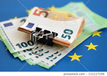 European euro currency money notes bunch on Europe union blue flag close up European euro currency money notes bunch on Europe union blue flag close up 131227246