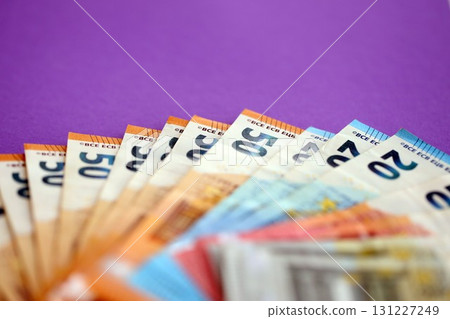 Big amount of european euro currency money notes on purple color table close up Big amount of european euro currency money notes on purple color table close up 131227249