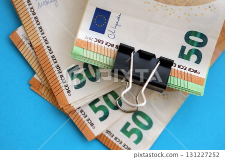 Big amount of european euro currency money notes on blue color table close up Big amount of european euro currency money notes on blue color table close up 131227252