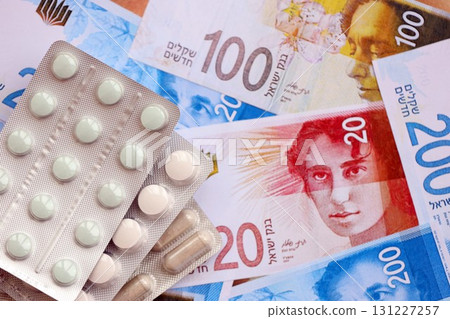 Israel New Shekels banknotes and medicine pills. The current Israel money bills and drugs Israel New Shekels banknotes and medicine pills. The current Israel money bills and drugs 131227257