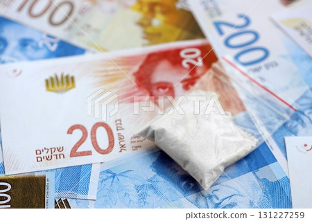 Israel New Shekels banknotes and cocaine pack. The current Israel money bills and narcotic substance Israel New Shekels banknotes and cocaine pack. The current Israel money bills and narcotic substance 131227259