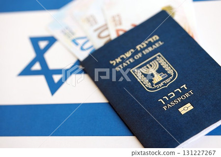 Israel New Shekels banknotes and passport on flag. The current Israel money bills and pass 131227267