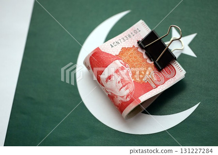 Pakistan rupees banknotes on Pakistani flag. The current Pakistan money bills Pakistan rupees banknotes on Pakistani flag. The current Pakistan money bills 131227284