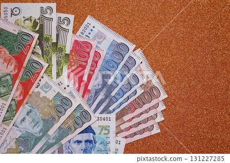 Pakistan rupees banknotes on golden yellow background. The current Pakistan money bills Pakistan rupees banknotes on golden yellow background. The current Pakistan money bills 131227285