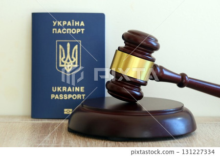 Judge hammer and ukrainian passport on brown background. Passport Of Ukraine Judge hammer and ukrainian passport on brown background. Passport Of Ukraine 131227334