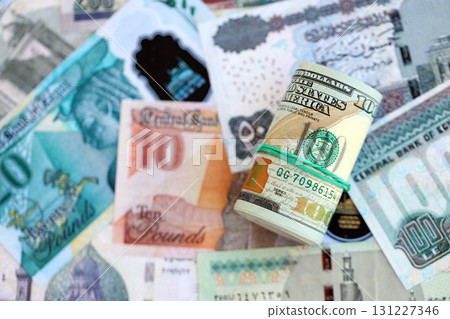 Egyptian pound currency money bills and bunch of us dollars. The concept of currency exchange Egyptian pound currency money bills and bunch of us dollars. The concept of currency exchange 131227346