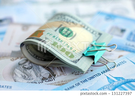 United Arab Emirates dirham currency money bills and bunch of us dollar banknotes. The concept of economics and currency exchange 131227397