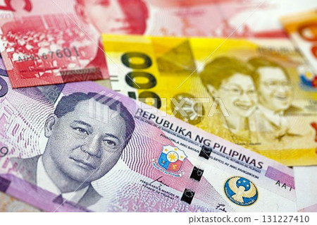 Philippines peso currency money bills. The current banknotes lies on table in big amount Philippines peso currency money bills. The current banknotes lies on table in big amount 131227410
