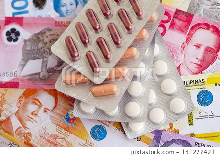 Philippines peso currency money bills and medicine pills. The concept of medicine and pharmacy Philippines peso currency money bills and medicine pills. The concept of medicine and pharmacy 131227421