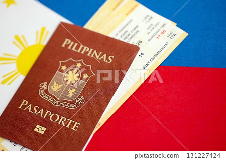 Philippines passport and boarding pass tickets on flag. The concept of travel and vacation Philippines passport and boarding pass tickets on flag. The concept of travel and vacation 131227424