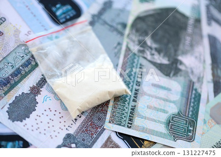 Egyptian pound currency money bills and cocaine pack. The concept of drug trafficking 131227475