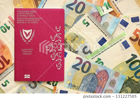 Kyprus passport lies on big amount of euro money banknotes. Rich life and travel in Europe Kyprus passport lies on big amount of euro money banknotes. Rich life and travel in Europe 131227505