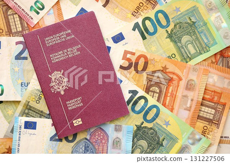 Belgium passport lies on big amount of euro money banknotes. Rich life and travel in Europe Belgium passport lies on big amount of euro money banknotes. Rich life and travel in Europe 131227506