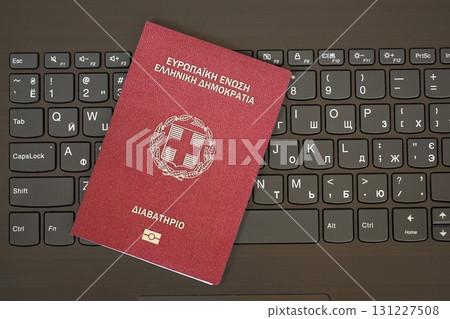 Greece passport lies on black laptop keyboard buttons background . Technologies in Europe 131227508