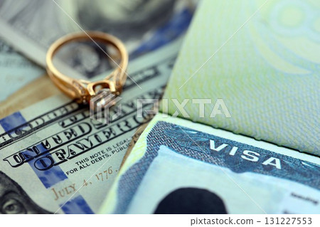 American VISA Marriage or Bride K-1 in United States of America close up. Gold ring with diamond 131227553