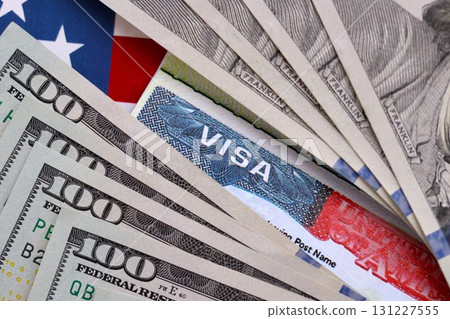 Travel visa background, Work and Travel VISA, Immigration with Dollars banknotes on US flag Travel visa background, Work and Travel VISA, Immigration with Dollars banknotes on US flag 131227555