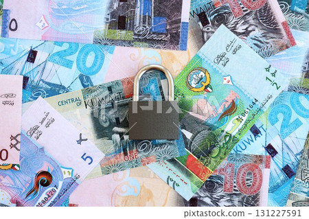 Kuwaiti dinar currency money bills and padlock. The concept of sanctions and financial safety Kuwaiti dinar currency money bills and padlock. The concept of sanctions and financial safety 131227591