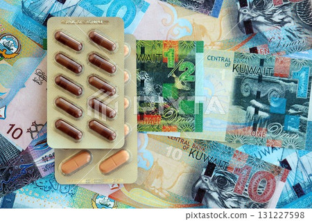 Kuwaiti dinar currency money bills and medicine pills. The concept of medicine and pharmacy 131227598