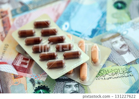 Bahraini dinar currency money bills and medicine pills. The concept of medicine and pharmacy Bahraini dinar currency money bills and medicine pills. The concept of medicine and pharmacy 131227622