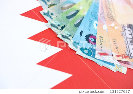 Bahraini dinar currency money bills lies on flag. The concept of business and investment Bahraini dinar currency money bills lies on flag. The concept of business and investment 131227627