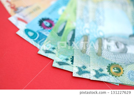 Bahraini dinar money bills in big amount on red. Finance and banking concept Bahraini dinar money bills in big amount on red. Finance and banking concept 131227629