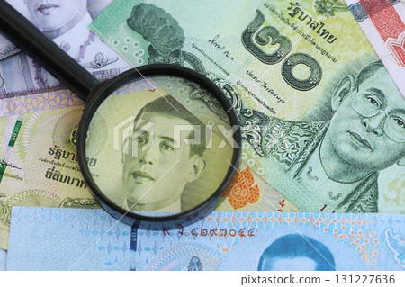 Thai baht currency money bills and magnifying glass. The concept of financial monitoring 131227636