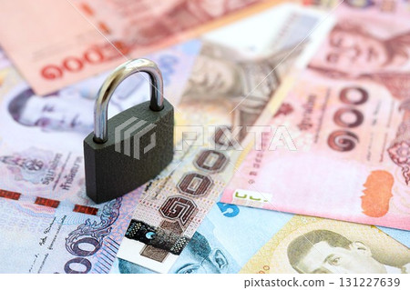 Thai baht currency money bills and padlock. The concept of sanctions and financial safety 131227639