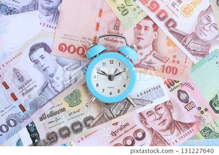 Thai baht currency money bills and alarm clock. The concept of time management and income 131227640