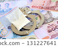 Thai baht currency money bills and cocaine pack with handcuffs. The concept of drug crimes 131227641