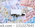 Thai baht currency money bills and toy delivery truck. The concept of delivery and logistics 131227645