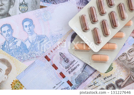 Thai baht currency money bills and medicine pills. The concept of medicine and pharmacy Thai baht currency money bills and medicine pills. The concept of medicine and pharmacy 131227646