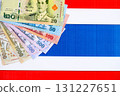 Thai baht currency money bills lies on flag. The concept of business and investment 131227651