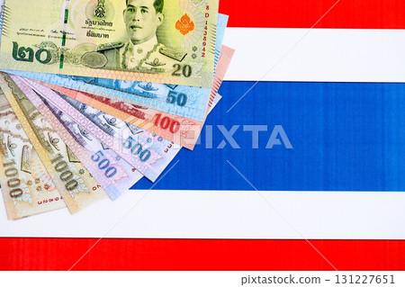 Thai baht currency money bills lies on flag. The concept of business and investment 131227651