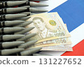 Thai baht currency money bills and rifle bullets on flag. Concept of warfare and gun selling 131227652