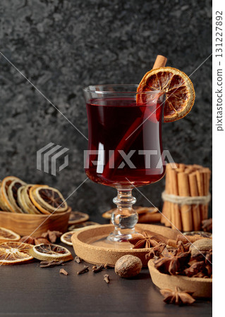 Mulled wine with ingredients and dry orange slices. 131227892