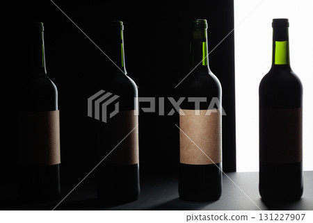 Red wine bottles silhouette over black background. Red wine bottles silhouette over black background. 131227907