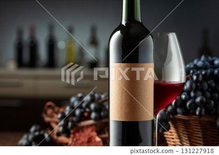 Bottle and glass of red wine with blue grapes. Bottle and glass of red wine with blue grapes. 131227918