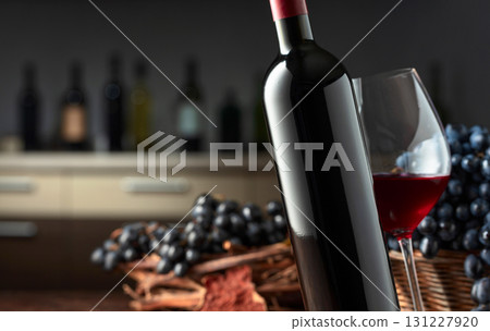 Bottle and glass of red wine with blue grapes. Bottle and glass of red wine with blue grapes. 131227920
