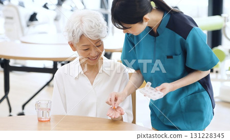 Elderly Asian people receiving medicine 131228345