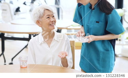 Elderly Asian people receiving medicine Elderly Asian people receiving medicine 131228346