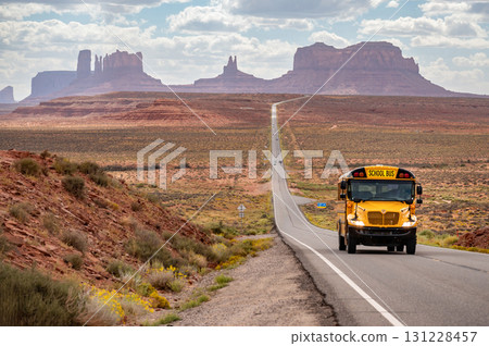 Yellow school bus on US highway route 163 at Forrest Gump Point, Utah, USA 131228457
